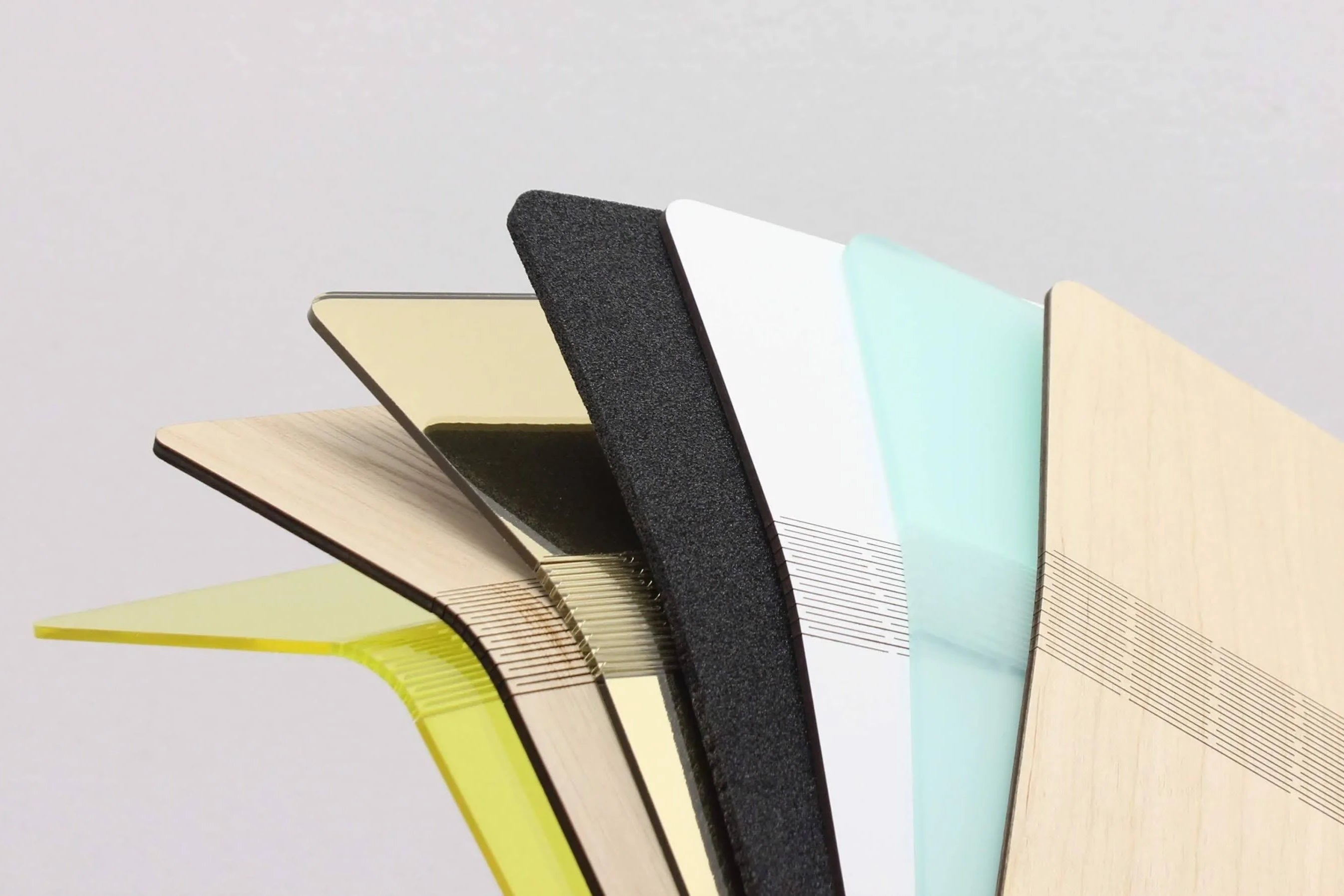 Laser-cut sheets of acrylic, wood, foam, plywood and mdf with a sninge (flexible hinge) in them