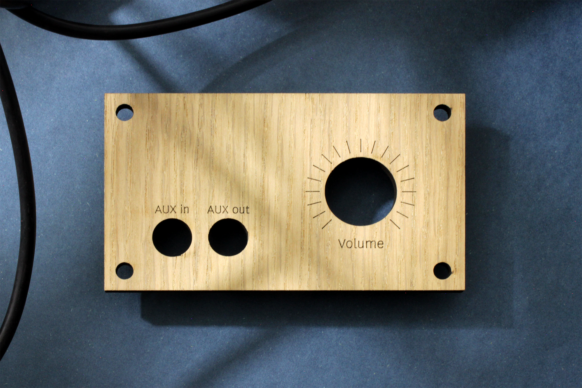 Laser cut and line engraving audio front panel from oak wood