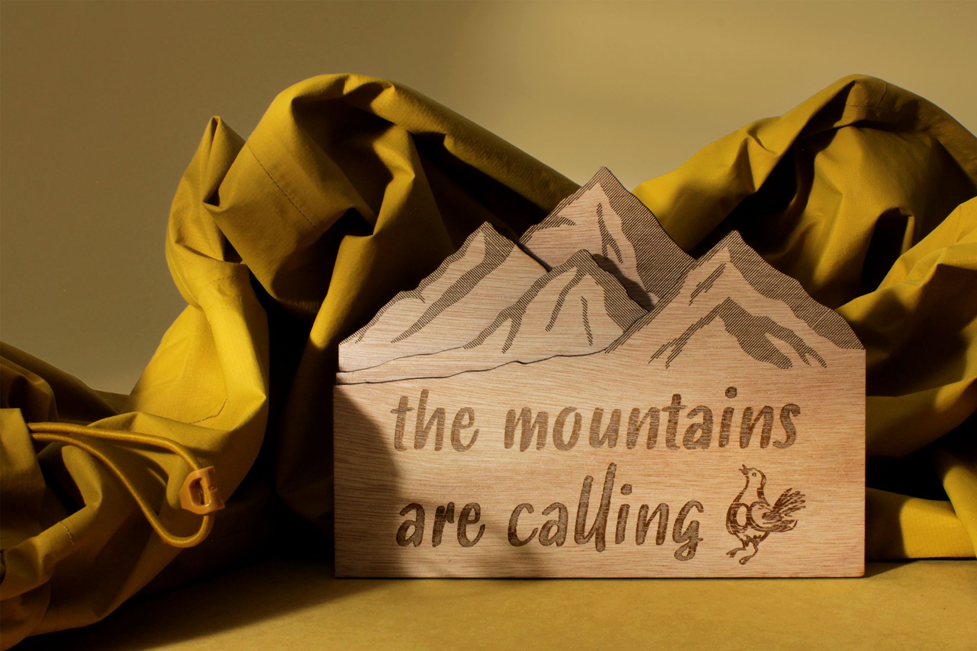 Plate with mountains and text from mahogany laser cut and engraved 