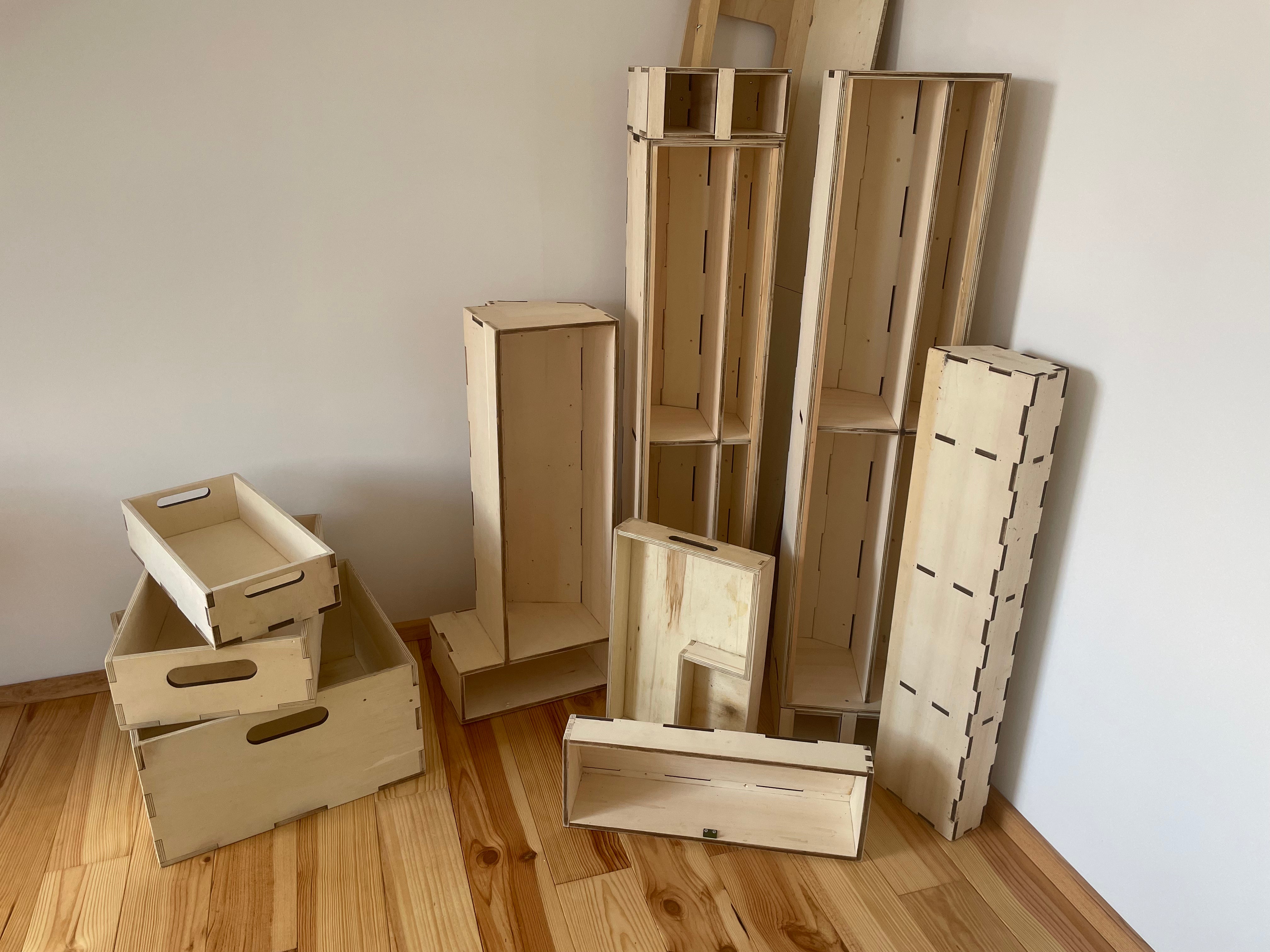 Pile of laser cut plywood cabinets in various shapes and sizes